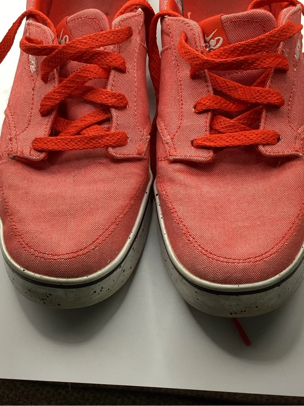 Nike 6.0 skate shoes featuring a vibrant red canvas upper and a speckled midsole